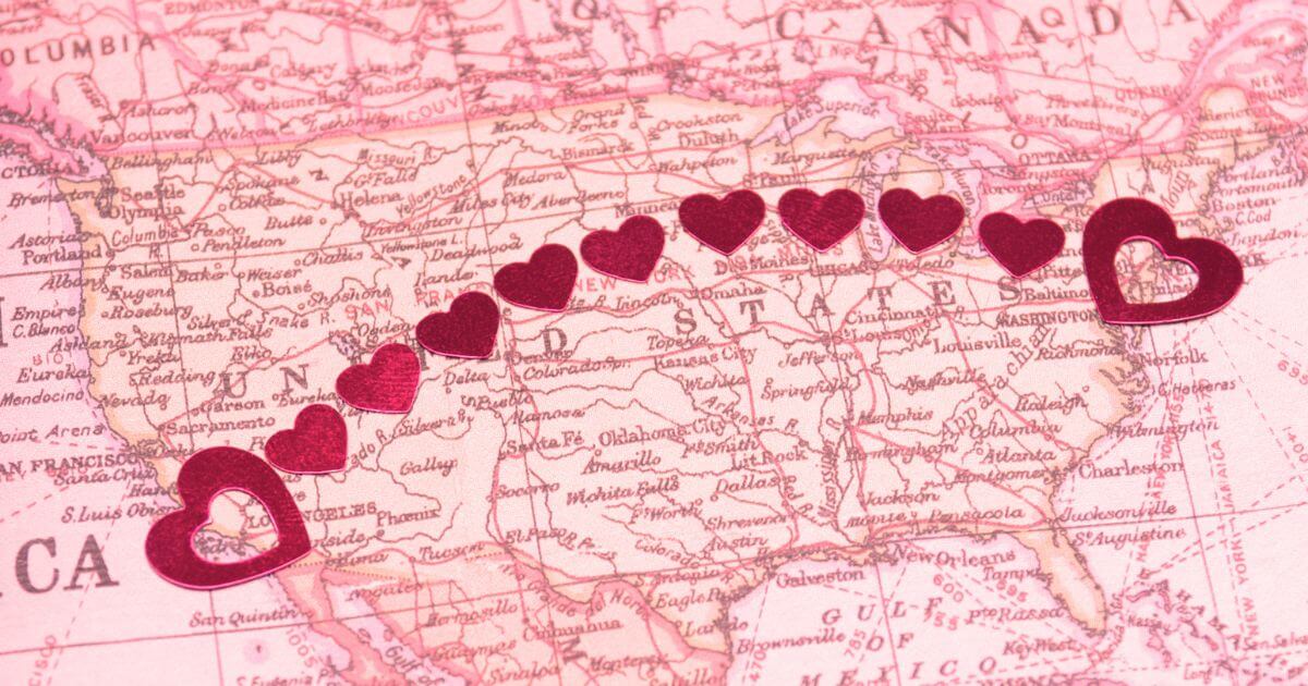 An image of the US map with a trail of hearts drawn from one end of the map to the other.