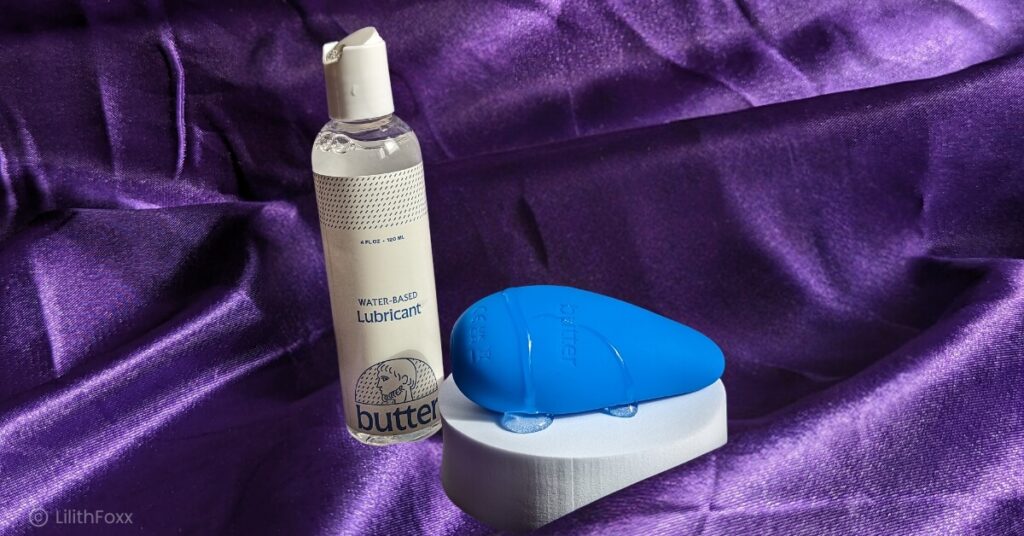 An image of Butter Wellness the water-based lubricant and the personal massager. The massager is covered in the water-based lube.