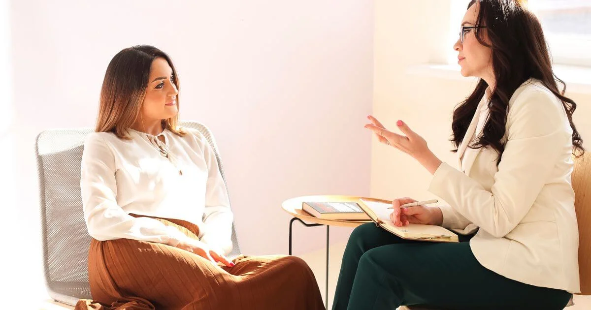Sex and relationship coach speaking with a client during a private coaching session.
