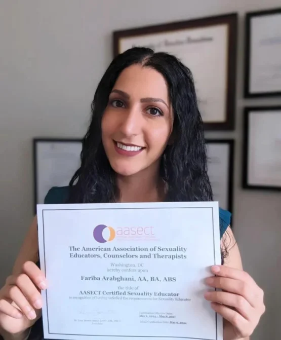 Lilithfoxx holding her AASECT certification certificate. She is a polyamory and kink coach.