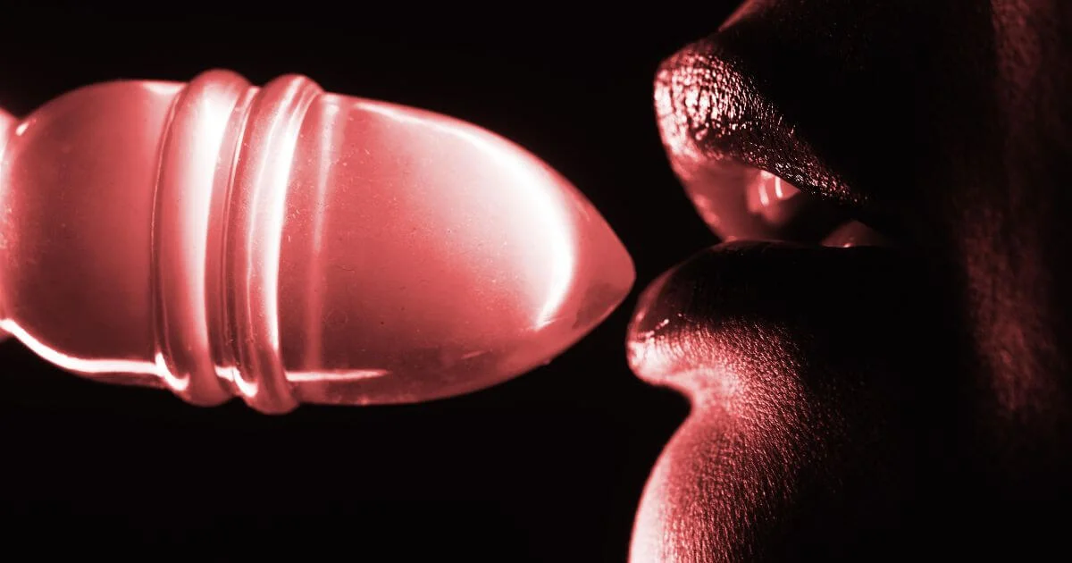 Close-up of two people in an intimate moment with a glowing object, representing sex positivity, pleasure, and consensual sexual exploration.
