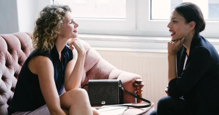 Two women talking during a private sexuality coaching session, representing supportive conversations about intimacy, communication, relationships, and sexual well-being.